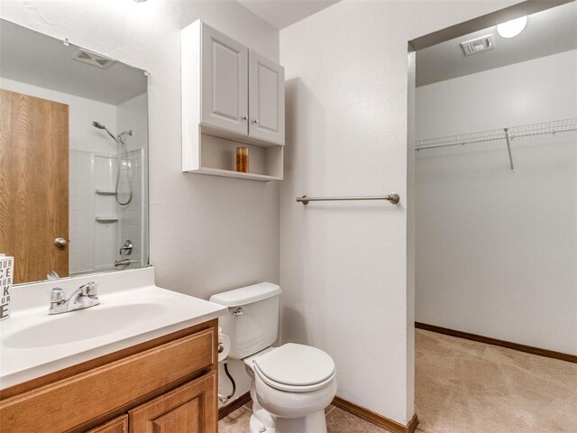 4537 SE 80th St, Del City, OK 73135 - full bathroom featuring a shower, vanity, toilet, a spacious closet, and baseboards