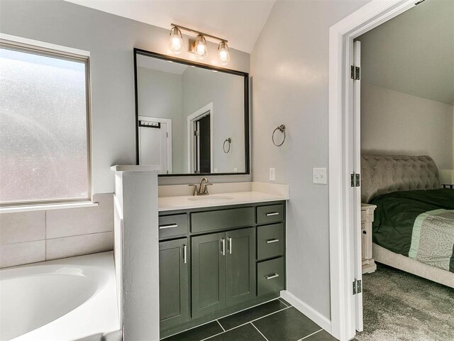 16125 Buffalo Dr, Moore, OK 73170 - bathroom with connected bathroom, lofted ceiling, vanity, a tub, and baseboards
