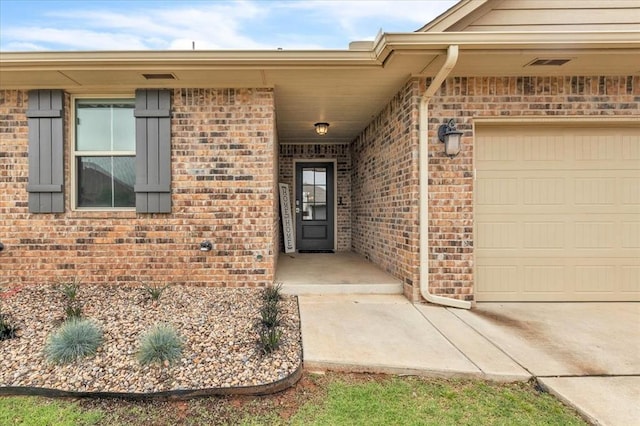 7224 NW 146th St, Oklahoma City, OK 73142 - property entrance featuring a garage and brick siding