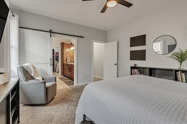 7224 NW 146th St, Oklahoma City, OK 73142 - bedroom with light colored carpet, a barn door, baseboards, a ceiling fan, and connected bathroom