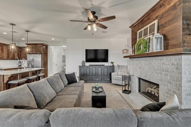 7224 NW 146th St, Oklahoma City, OK 73142 - living room with a ceiling fan, recessed lighting, a fireplace, and light wood-style floors