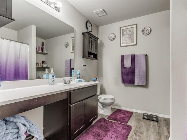 9436 SW 37th St, Oklahoma City, OK 73179 - full bathroom featuring vanity, toilet, wood finished floors, and baseboards