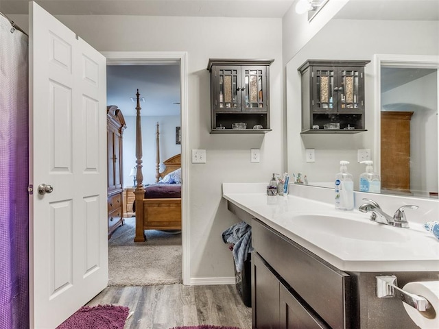 9436 SW 37th St, Oklahoma City, OK 73179 - full bathroom with vanity, wood finished floors, connected bathroom, and baseboards