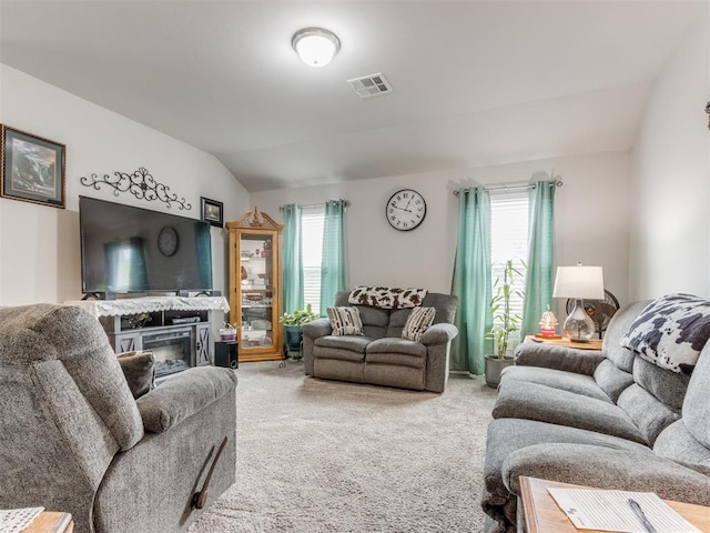 9436 SW 37th St, Oklahoma City, OK 73179 - living area featuring carpet flooring, vaulted ceiling, and a glass covered fireplace