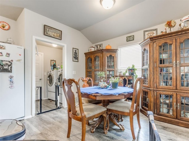 9436 SW 37th St, Oklahoma City, OK 73179 - dining area with washing machine and clothes dryer, light wood-style flooring, and vaulted ceiling