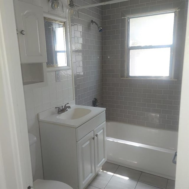 7123 NW 44th St, Bethany, OK 73008 - bathroom featuring toilet, tile patterned flooring, vanity, shower / tub combination, and healthy amount of natural light