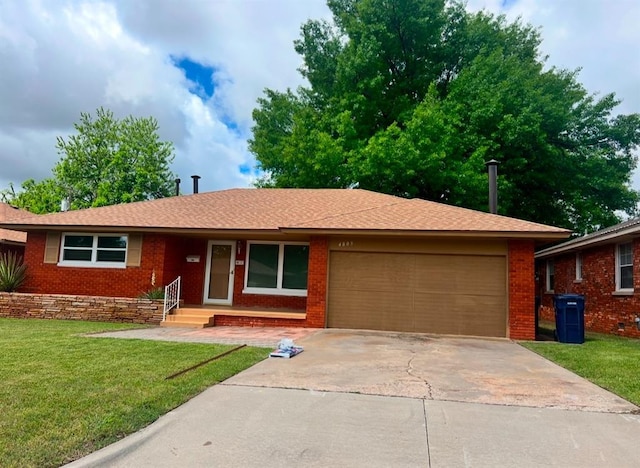 4809 N Pate Ave, Oklahoma City, OK 73112 - ranch-style house featuring an attached garage, concrete driveway, a front yard, and brick siding