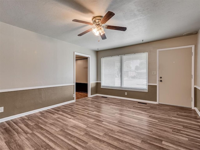 4809 N Pate Ave, Oklahoma City, OK 73112 - empty room featuring wood finished floors, a textured ceiling, a ceiling fan, and baseboards