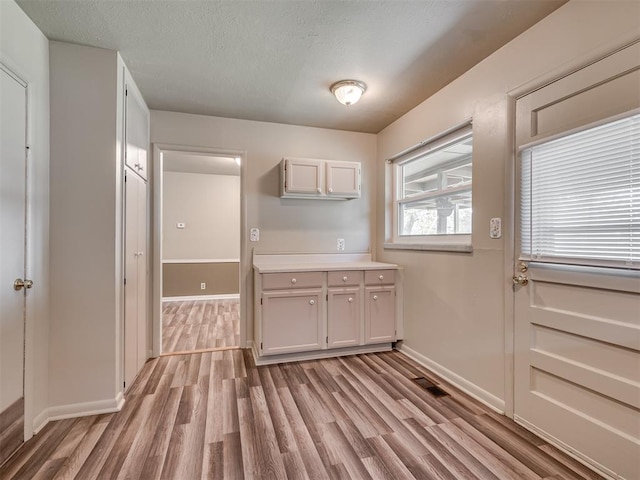 4809 N Pate Ave, Oklahoma City, OK 73112 - entryway with light wood-style floors, baseboards, and a textured ceiling