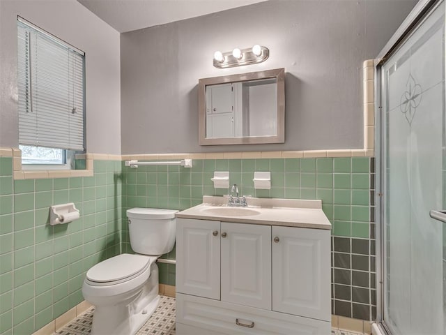 4809 N Pate Ave, Oklahoma City, OK 73112 - bathroom with tile walls, a wainscoted wall, toilet, vanity, and a shower stall