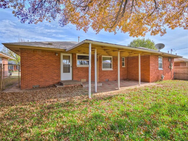 4809 N Pate Ave, Oklahoma City, OK 73112 - rear view of house featuring brick siding, a patio area, and a gate