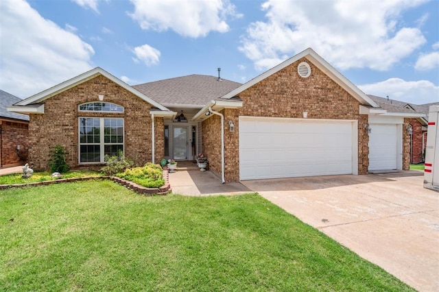 2632 SE 97th St, Moore, OK 73160 - view of front of house featuring a garage, driveway, a front lawn, and brick siding