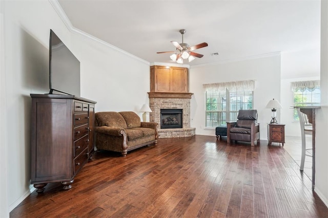 2632 SE 97th St, Moore, OK 73160 - living room with dark wood-style floors, ceiling fan, crown molding, a brick fireplace, and baseboards