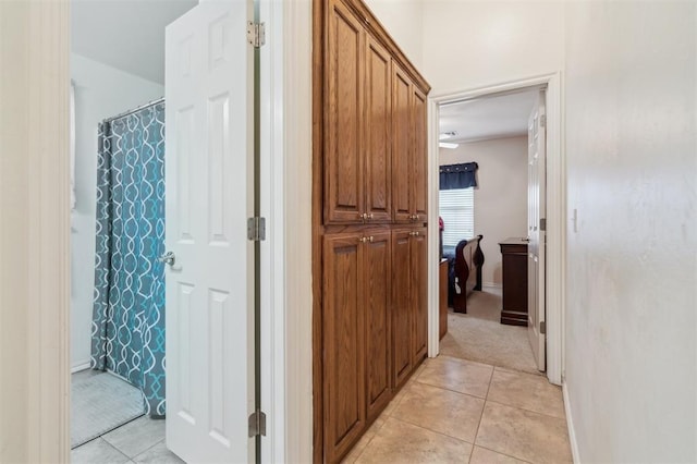 2632 SE 97th St, Moore, OK 73160 - hallway with light tile patterned floors, baseboards, and light carpet