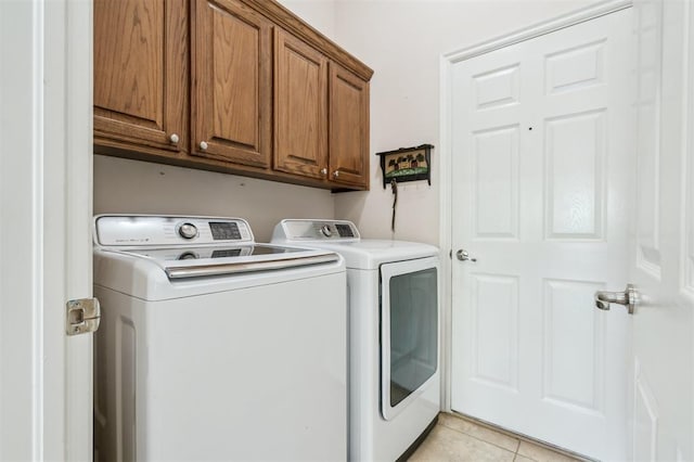 2632 SE 97th St, Moore, OK 73160 - washroom with separate washer and dryer, cabinet space, and light tile patterned flooring