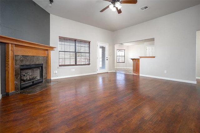 1704 Sumac Dr, Norman, OK 73071 - unfurnished living room featuring ceiling fan, wood finished floors, a fireplace, and baseboards