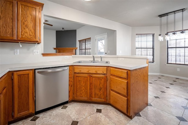 1704 Sumac Dr, Norman, OK 73071 - kitchen featuring dishwasher, a sink, a peninsula, and brown cabinets