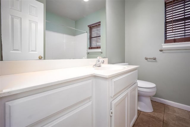 1704 Sumac Dr, Norman, OK 73071 - full bathroom with toilet, vanity, a shower, tile patterned floors, and baseboards