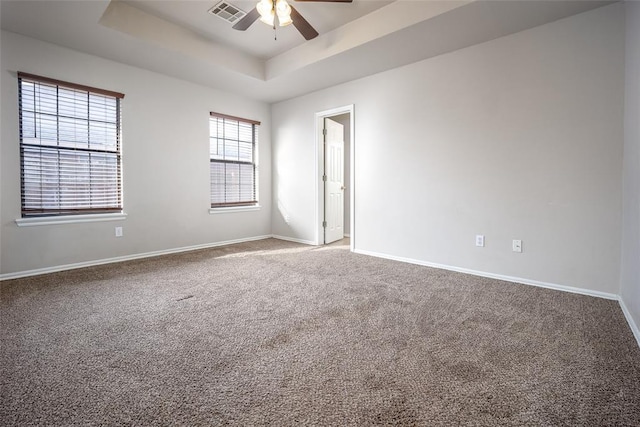 1704 Sumac Dr, Norman, OK 73071 - carpeted empty room with a tray ceiling, ceiling fan, and baseboards