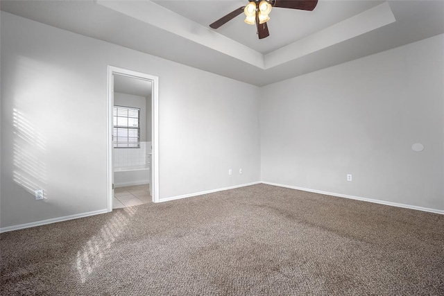 1704 Sumac Dr, Norman, OK 73071 - carpeted spare room with a ceiling fan, baseboards, and a raised ceiling