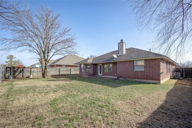 1704 Sumac Dr, Norman, OK 73071 - rear view of property with brick siding, a chimney, central AC unit, and roof with shingles