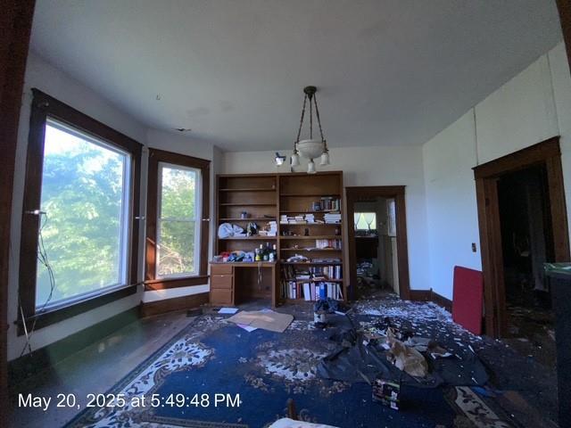 820 NW E St, Ardmore, OK 73401 - unfurnished dining area featuring concrete floors, baseboards, and a chandelier
