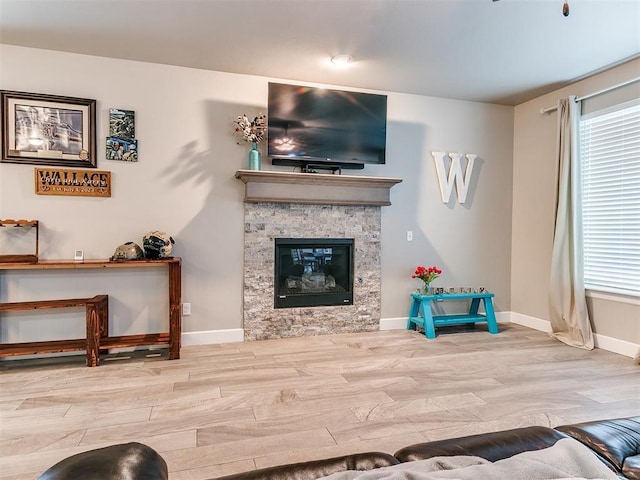 1405 Atalon Dr, Moore, OK 73160 - living room with wood finished floors, baseboards, and a stone fireplace