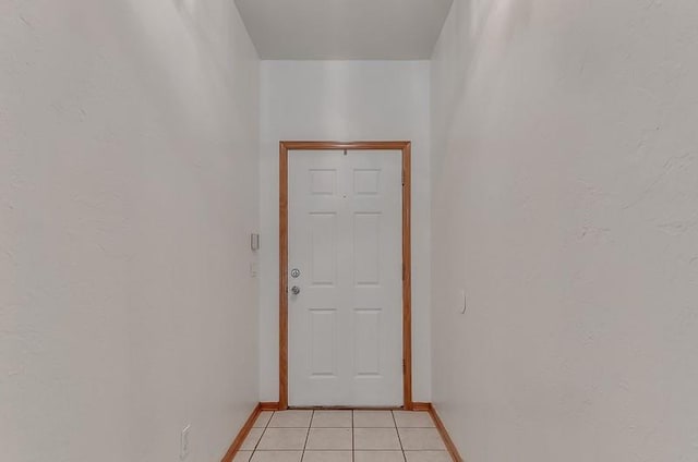 2121 NE 13th St, Moore, OK 73160 - doorway to outside with baseboards and light tile patterned flooring