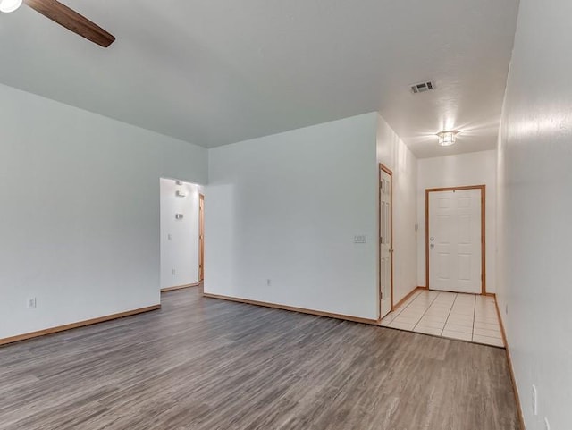 2121 NE 13th St, Moore, OK 73160 - spare room with wood finished floors, a ceiling fan, and baseboards