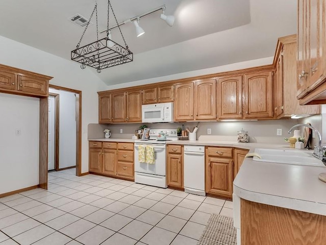 2121 NE 13th St, Moore, OK 73160 - kitchen with white appliances, a sink, rail lighting, light countertops, and light tile patterned floors