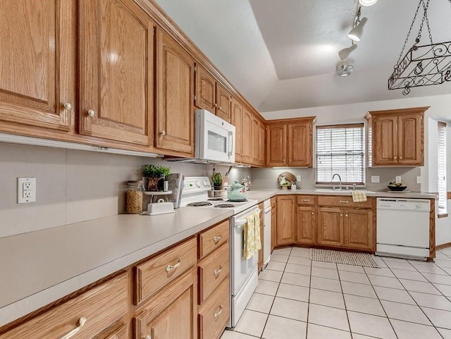 2121 NE 13th St, Moore, OK 73160 - kitchen with white appliances, a sink, light countertops, light tile patterned flooring, and brown cabinetry