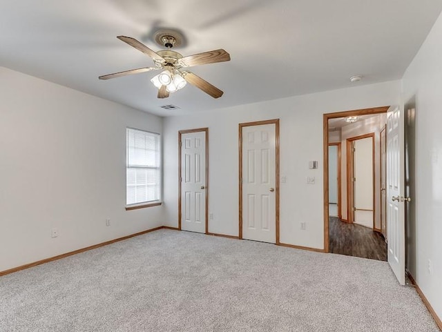 2121 NE 13th St, Moore, OK 73160 - unfurnished bedroom with carpet flooring, baseboards, and ceiling fan