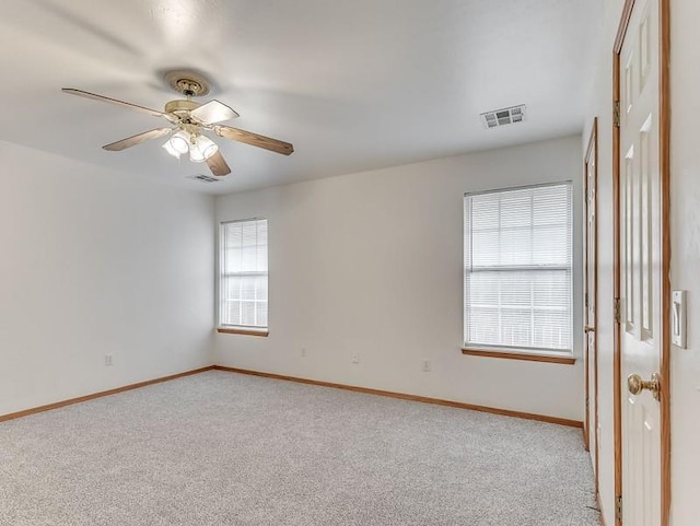 2121 NE 13th St, Moore, OK 73160 - spare room with light colored carpet, baseboards, and ceiling fan
