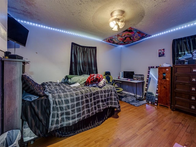 3605 Mount Pleasant Dr, Oklahoma City, OK 73110 - bedroom featuring a textured ceiling and wood-type flooring