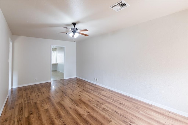 515 N Booth Ave, Elk City, OK 73644 - empty room featuring a ceiling fan, wood finished floors, and baseboards
