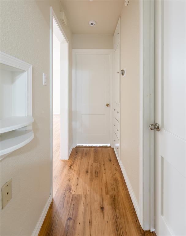 515 N Booth Ave, Elk City, OK 73644 - hall featuring light wood-style floors and baseboards