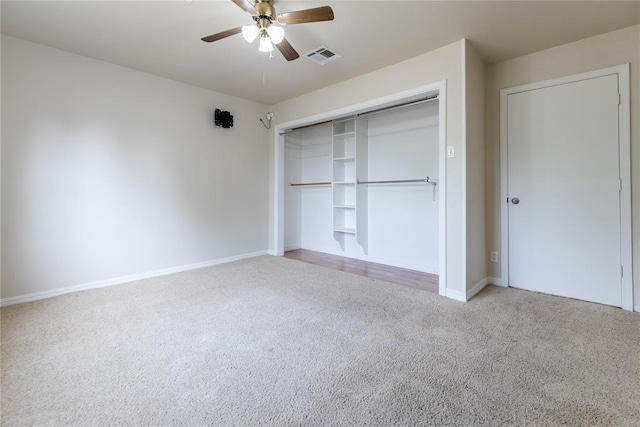 515 N Booth Ave, Elk City, OK 73644 - unfurnished bedroom with carpet, baseboards, a closet, and ceiling fan