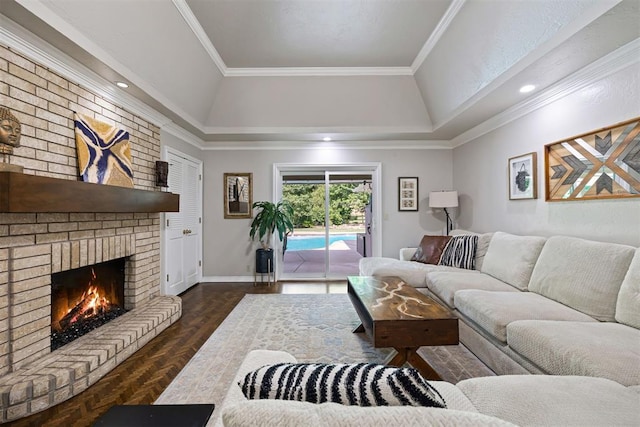 1704 Faircloud Dr, Edmond, OK 73034 - living room featuring a brick fireplace, a tray ceiling, baseboards, and crown molding