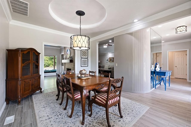 1704 Faircloud Dr, Edmond, OK 73034 - dining area featuring a fireplace, ceiling fan, baseboards, wood tiled floors, and recessed lighting