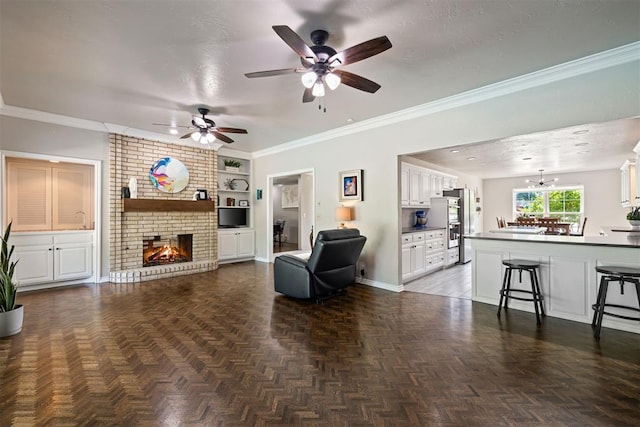 1704 Faircloud Dr, Edmond, OK 73034 - living room featuring ceiling fan, built in shelves, a fireplace, baseboards, and ornamental molding