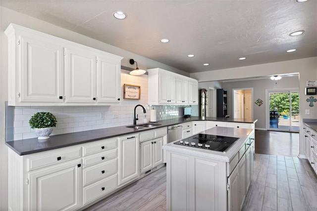 1704 Faircloud Dr, Edmond, OK 73034 - kitchen featuring a sink, black electric cooktop, decorative backsplash, wood tiled floors, and recessed lighting