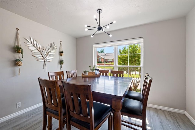 1704 Faircloud Dr, Edmond, OK 73034 - dining room with a chandelier, light wood-style floors, and baseboards