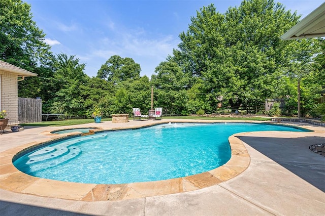 1704 Faircloud Dr, Edmond, OK 73034 - view of pool featuring a patio, view of scattered trees, and a pool with connected hot tub