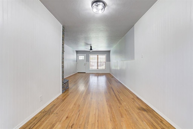 1206 Monroe Dr, Shawnee, OK 74804 - unfurnished living room featuring light wood-type flooring, a ceiling fan, and baseboards