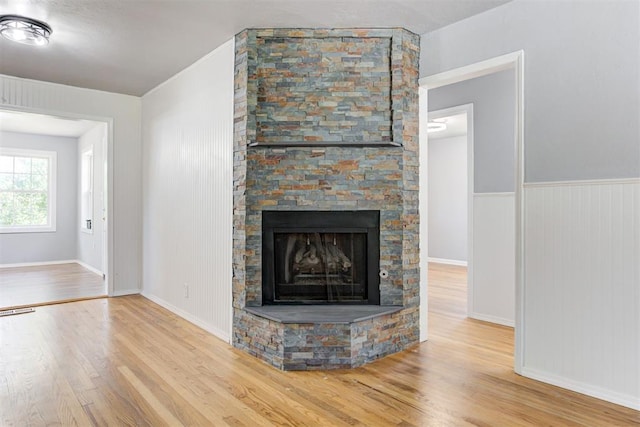 1206 Monroe Dr, Shawnee, OK 74804 - unfurnished living room with wood finished floors, a fireplace, and baseboards