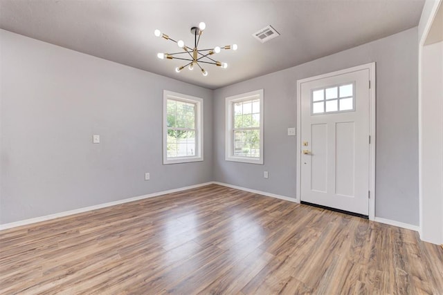 1206 Monroe Dr, Shawnee, OK 74804 - foyer entrance featuring a chandelier, baseboards, and wood finished floors