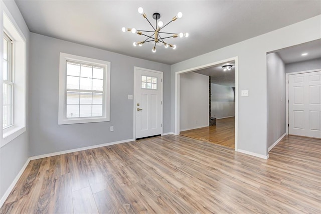 1206 Monroe Dr, Shawnee, OK 74804 - foyer entrance with a chandelier, light wood-type flooring, and baseboards