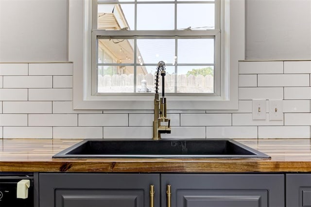 1206 Monroe Dr, Shawnee, OK 74804 - kitchen view of a sink, gray cabinets, and dark countertops