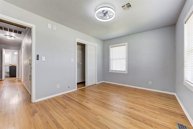 1206 Monroe Dr, Shawnee, OK 74804 - unfurnished bedroom featuring light wood-style floors, baseboards, and a closet