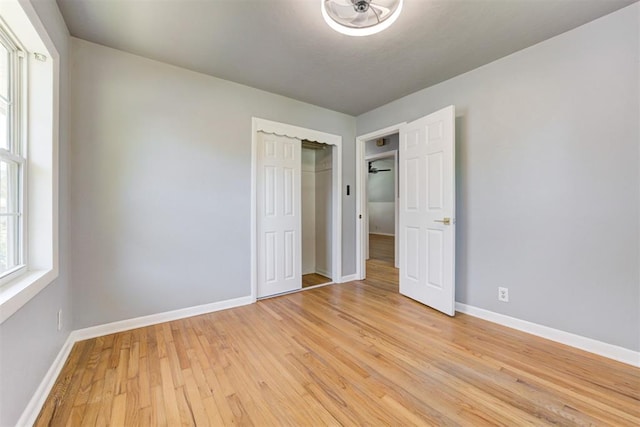 1206 Monroe Dr, Shawnee, OK 74804 - unfurnished bedroom with light wood-style floors, baseboards, and a closet